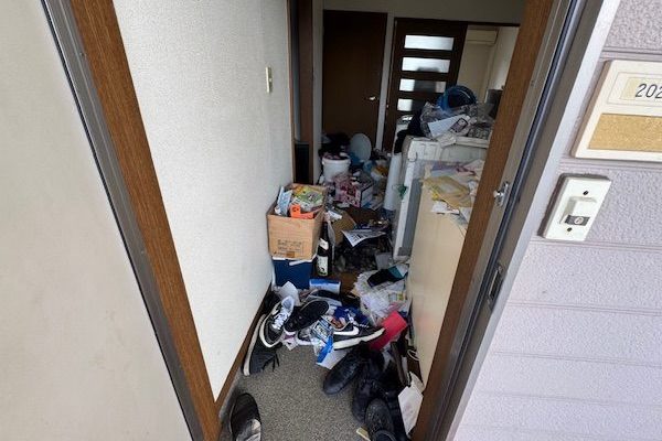 東京都江東区の床の上に物が多く、乱雑な印象を受ける玄関からの光景
